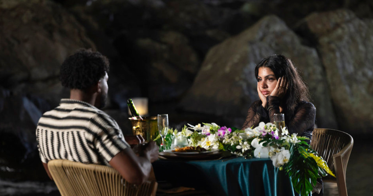 Huda and Chris sit opposite one another on Love Island USA